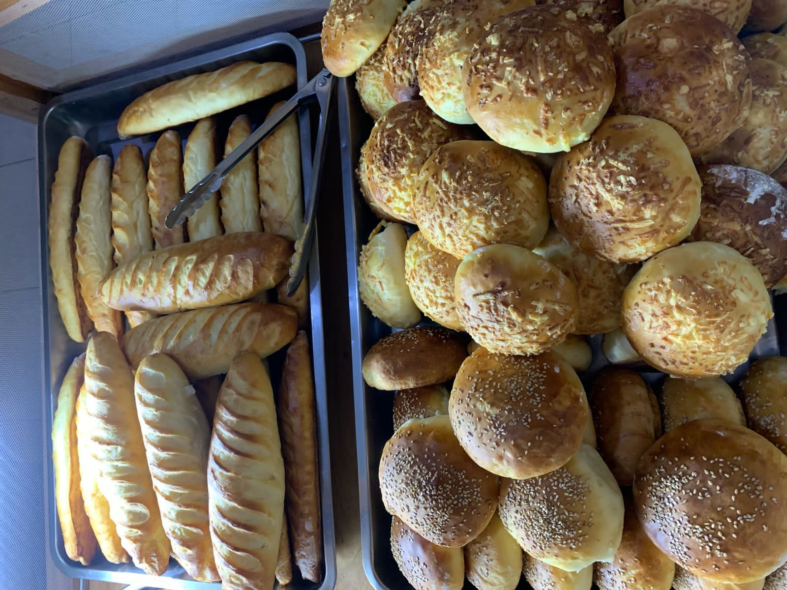 Multiple trays of freshly baked French bread